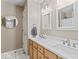 Bright bathroom features double sinks with light wood cabinetry and neutral countertops at 9950 Sugarleaf Pl, Fishers, IN 46038