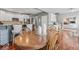 Open concept dining space showcasing wood floors connecting to kitchen and living areas at 9950 Sugarleaf Pl, Fishers, IN 46038