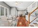 Open floor plan with hardwood floors, dining room, and view into living room at 9950 Sugarleaf Pl, Fishers, IN 46038