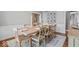 Stylish dining room featuring a wooden table, chairs, and natural light from the window at 9950 Sugarleaf Pl, Fishers, IN 46038