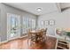 Inviting dining area with wood floors, a round table, and a sliding glass door to the patio at 9950 Sugarleaf Pl, Fishers, IN 46038