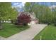 Beautiful exterior elevation showcasing a two-car garage, basketball court, and large driveway at 9950 Sugarleaf Pl, Fishers, IN 46038