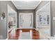 Entryway with hardwood floors and views of dining and living room spaces at 9950 Sugarleaf Pl, Fishers, IN 46038