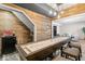 Game room showcasing a shuffleboard table, wood accents, and a convenient drink station at 9950 Sugarleaf Pl, Fishers, IN 46038