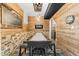 Game room with wood-paneled walls, shuffleboard table, and stylish lighting at 9950 Sugarleaf Pl, Fishers, IN 46038