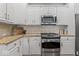 Well-equipped kitchen featuring granite countertops, modern appliances, and white cabinetry at 9950 Sugarleaf Pl, Fishers, IN 46038