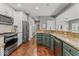 Open kitchen with granite counters, wood floors, stainless appliances, and an eat-in bar at 9950 Sugarleaf Pl, Fishers, IN 46038