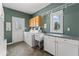 Efficient laundry room equipped with modern washer, dryer, ample counter space, and custom cabinets at 9950 Sugarleaf Pl, Fishers, IN 46038
