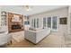 Comfortable living room featuring a brick fireplace, built-in shelving, and natural light at 9950 Sugarleaf Pl, Fishers, IN 46038