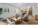 Carpeted living room with staircase, sofa, and view to the dining area at 9950 Sugarleaf Pl, Fishers, IN 46038