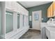 The mudroom features storage, hooks and a bench for easy organization with access to the back yard at 9950 Sugarleaf Pl, Fishers, IN 46038