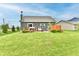Well-maintained backyard with lush green grass, a small deck, and mature landscaping at 998 Cass Dr, Franklin, IN 46131