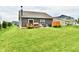 Lush backyard featuring a well-manicured lawn, complemented by a deck and mature landscaping for outdoor enjoyment at 998 Cass Dr, Franklin, IN 46131
