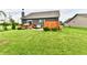 Beautifully landscaped backyard, complete with a deck, mature trees, and a well-kept lawn at 998 Cass Dr, Franklin, IN 46131