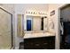 Modern bathroom featuring a double sink vanity, large mirror, and a glass-enclosed shower at 998 Cass Dr, Franklin, IN 46131