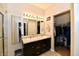 Bathroom with a double sink vanity, large mirror, and a view into the walk-in closet at 998 Cass Dr, Franklin, IN 46131