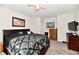 Well-lit bedroom with a decorative bed, carpeted floors, and neutral wall colors creating a serene atmosphere at 998 Cass Dr, Franklin, IN 46131