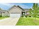 Charming brick home featuring a two-car garage, a manicured lawn, and a cozy front porch at 998 Cass Dr, Franklin, IN 46131