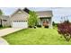 Lovely house with a large front yard, two-car garage, and inviting porch with bench seating at 998 Cass Dr, Franklin, IN 46131