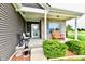 Cozy front porch with a comfortable bench, a 'Welcome' sign, and decorative shrubs at 998 Cass Dr, Franklin, IN 46131