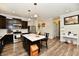 Kitchen features dark cabinets, stainless steel appliances, and a marble center island with seating at 998 Cass Dr, Franklin, IN 46131