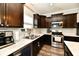 Updated kitchen with stainless steel appliances, marble counters and dark cabinets, and wood flooring at 998 Cass Dr, Franklin, IN 46131
