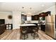 Bright kitchen features dark cabinets, stainless steel appliances, and a center island with seating for two at 998 Cass Dr, Franklin, IN 46131