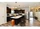 Bright kitchen features dark cabinets, stainless steel appliances, and a center island with white countertop at 998 Cass Dr, Franklin, IN 46131