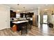 Modern kitchen features dark cabinets, stainless steel appliances, and a center island with marble countertop at 998 Cass Dr, Franklin, IN 46131