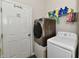Functional laundry room featuring a modern washer and dryer set with shelving at 998 Cass Dr, Franklin, IN 46131