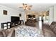 Spacious living room with hardwood floors, ceiling fan, and open view to kitchen with barstool seating at 998 Cass Dr, Franklin, IN 46131