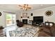 Spacious living room features hardwood floors, a ceiling fan, a fireplace, and leather sofas at 998 Cass Dr, Franklin, IN 46131