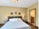 Cozy bedroom showcasing neutral decor and an ensuite bathroom for added convenience at 1026 Jackson St, Columbus, IN 47201