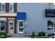 Modern townhome showcasing a light gray exterior with a covered entryway and a balcony at 1026 Jackson St, Columbus, IN 47201