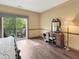 A serene bedroom features a balcony with lush views, complemented by a vanity, for relaxation and natural beauty at 1026 Jackson St, Columbus, IN 47201