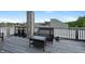 Relaxing rooftop deck with wicker furniture and a stunning cityscape view at 1026 Jackson St, Columbus, IN 47201