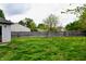 A spacious backyard features a lush lawn with a wooden fence securing the property at 107 Camelia Ct, Mooresville, IN 46158