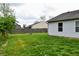 A green backyard shows the wooden fence and ample space for outdoor activities at 107 Camelia Ct, Mooresville, IN 46158