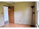 Bedroom featuring laminate floors, door to another room and an overhead track light at 107 Camelia Ct, Mooresville, IN 46158