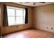 Bedroom with light-colored walls, wood-look flooring, a ceiling fan and bright window at 107 Camelia Ct, Mooresville, IN 46158