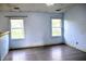 Spacious bedroom featuring modern vinyl floors, ceiling fan, and two windows for ample natural light at 107 Camelia Ct, Mooresville, IN 46158