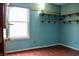 Bedroom featuring hardwood floors, corner shelving, and a bright window at 107 Camelia Ct, Mooresville, IN 46158