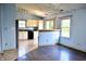 A view of the dining area showing the layout and connection to the kitchen with mixed flooring types at 107 Camelia Ct, Mooresville, IN 46158