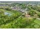 Aerial shot of a golf course community, showing lush greenery and water features at 11064 Hamilton Run, Zionsville, IN 46077