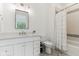 Bright bathroom with a granite vanity, decorative tile floor, and a bathtub with shower and tiled surround at 11064 Hamilton Run, Zionsville, IN 46077