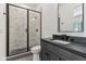 Bathroom featuring black fixtures, vanity with dark countertop, and glass enclosed shower at 11064 Hamilton Run, Zionsville, IN 46077