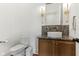 Elegant powder room featuring a vessel sink, granite countertop, modern lighting fixtures, and a toilet at 11064 Hamilton Run, Zionsville, IN 46077
