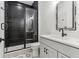 Modern bathroom with black subway tiles, glass shower, and a white vanity at 11064 Hamilton Run, Zionsville, IN 46077