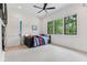 Well-lit bedroom with ceiling fan, a large window view, carpet, and a blue striped bed at 11064 Hamilton Run, Zionsville, IN 46077