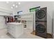 Large walk in closet with custom shelving, center island, and stacked washer and dryer at 11064 Hamilton Run, Zionsville, IN 46077
